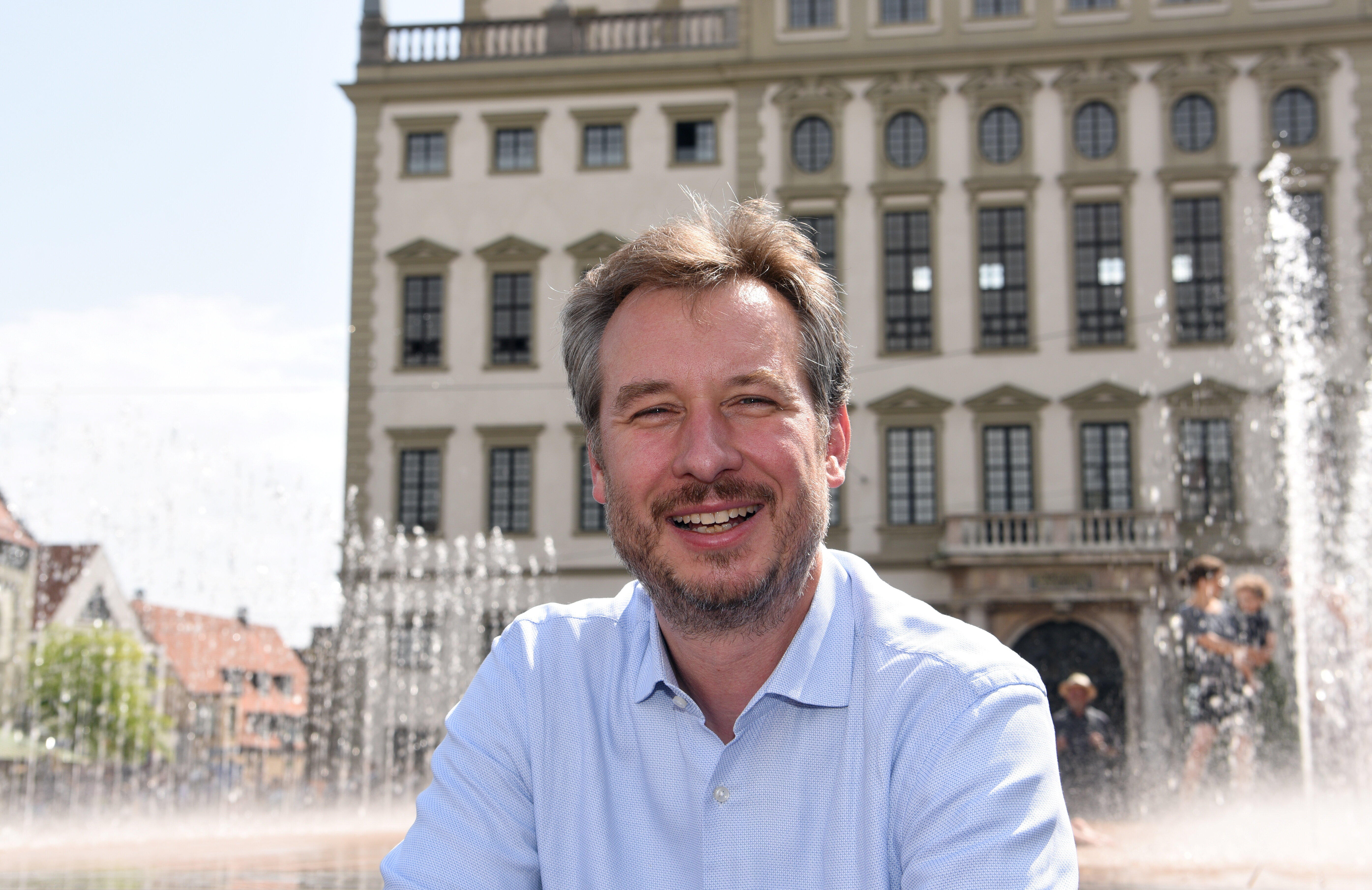 Steffen Kercher im Hemd vor dem Augsburger Rathaus