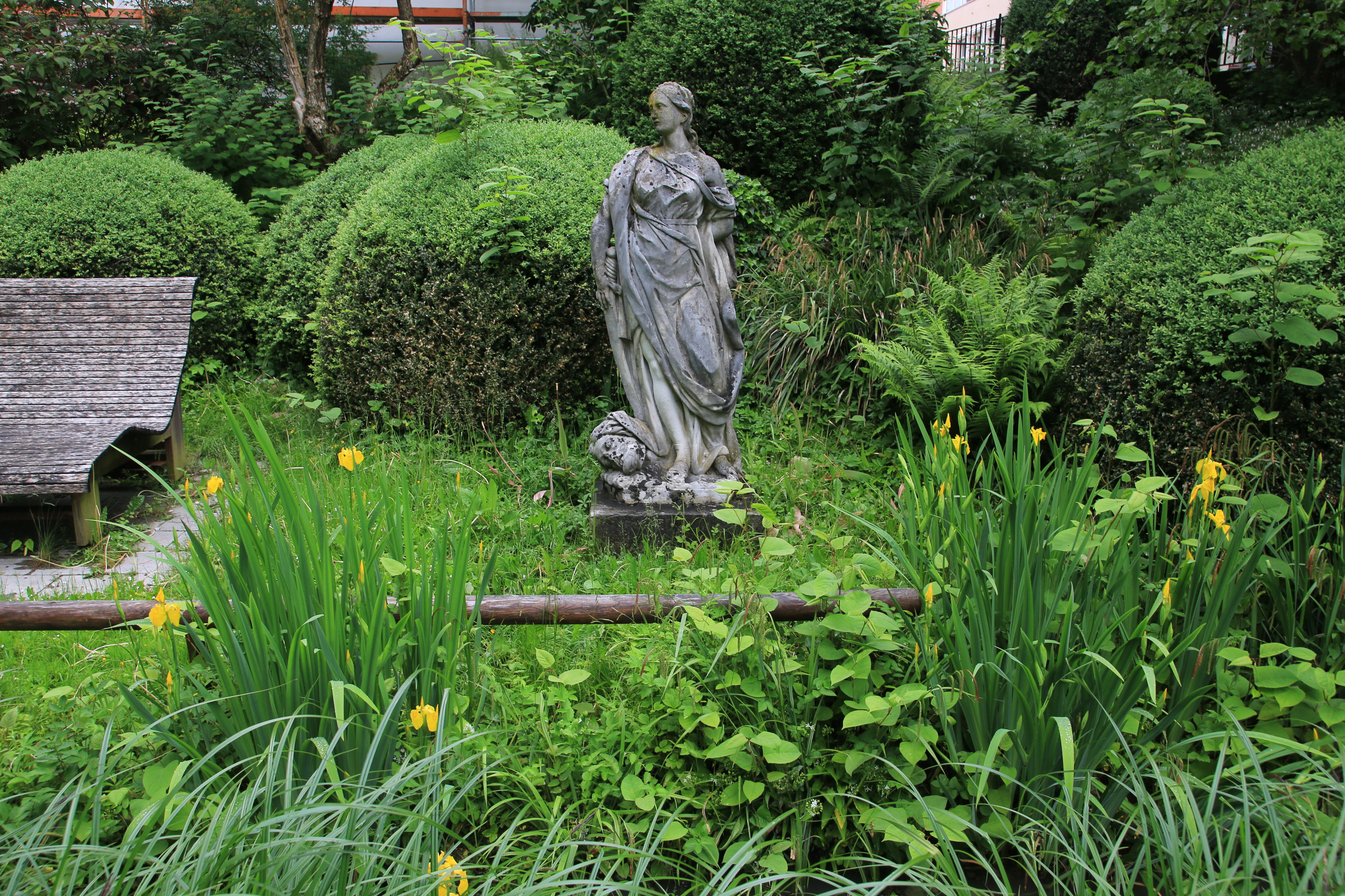 Blick ins Grüne mit barocker Gartenskulptur einer Flora
