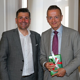 2 Männer lächeln in die Kamera